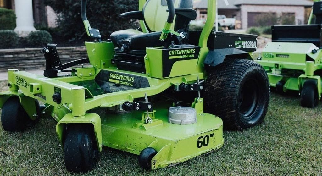 Green electric zero-turn mower cutting a lawn in Shreveport, LA