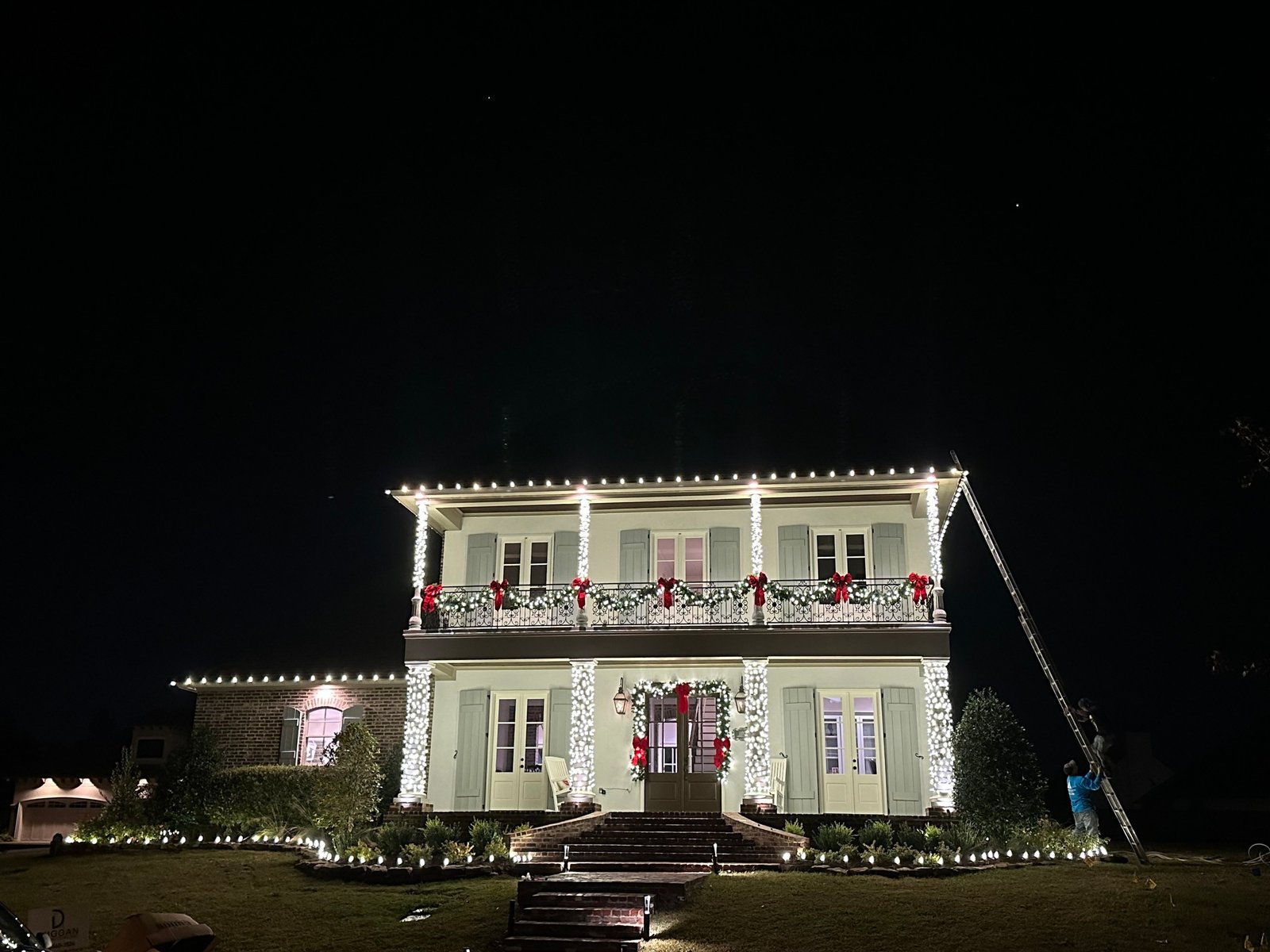 Two-story home with garland, wreaths and roofline lights in Shreveport