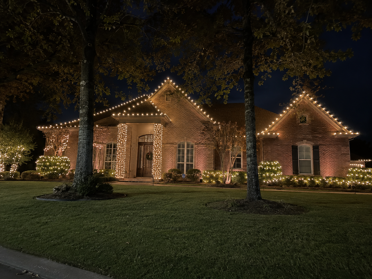 Classic warm white Christmas lights on a brick home in Shreveport