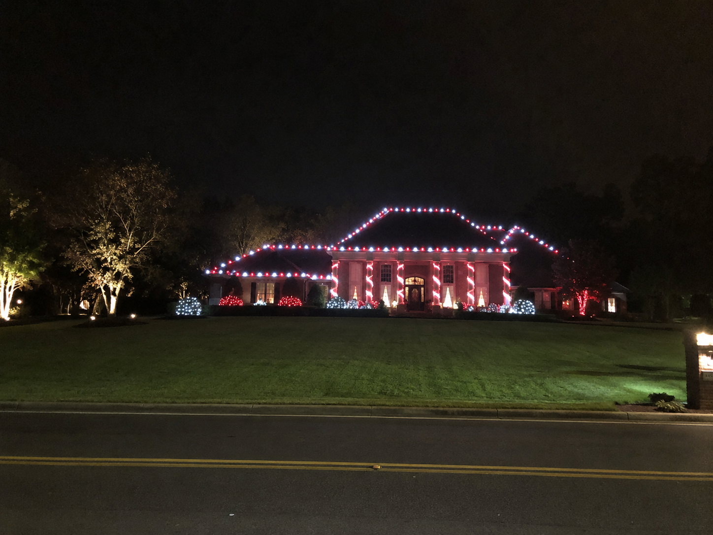 Red and white Christmas lights on a home in Bossier City